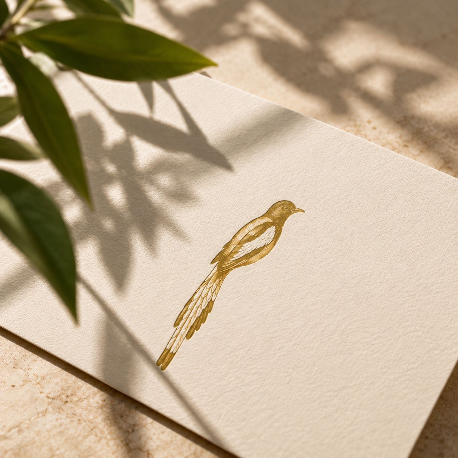 A gold foil-stamped emblem of the Betru dentist bird pressed into cream paper